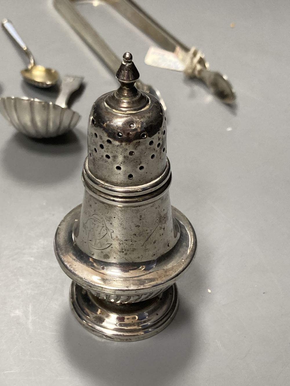 A pair of late Victorian silver pepperettes, London, 1891, 95mm, A George III silver caddy spoon, etc.